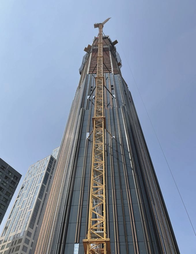 The Brooklyn Tower / 9 DeKalb — black-and-copper fluted curtain-wall detail rising against the sky